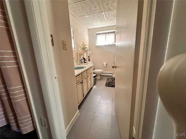 bathroom featuring tile patterned flooring, vanity, a baseboard radiator, and toilet