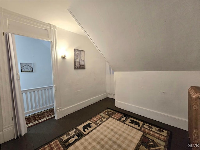 additional living space with dark hardwood / wood-style floors and lofted ceiling