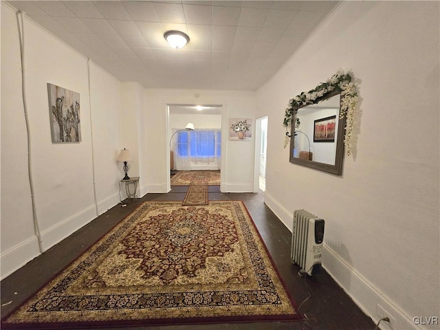 hall with radiator and dark hardwood / wood-style floors