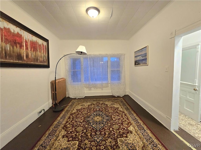 sitting room featuring radiator heating unit and dark wood-type flooring