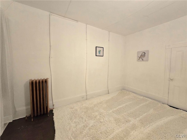 unfurnished bedroom featuring radiator