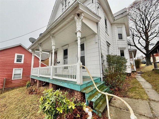 view of exterior entry with covered porch