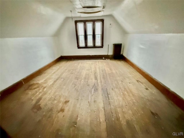 bonus room featuring hardwood / wood-style flooring and vaulted ceiling