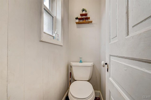 bathroom with toilet and a healthy amount of sunlight