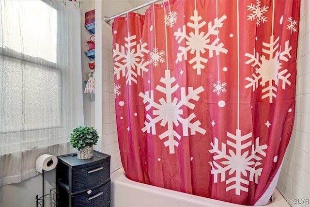 bathroom with shower / bath combination with curtain