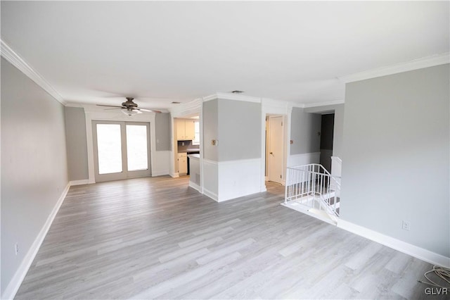 unfurnished living room with ceiling fan, light wood-type flooring, and ornamental molding