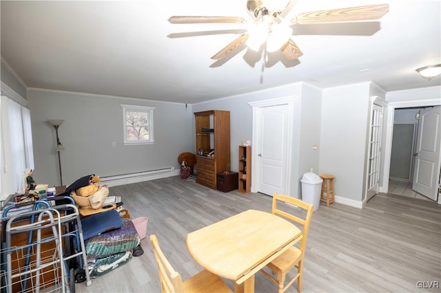 interior space with baseboard heating, ceiling fan, crown molding, and light wood-type flooring