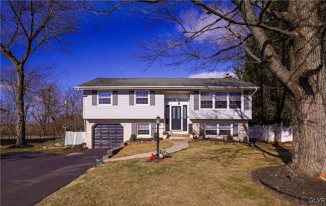 split foyer home with a front yard and a garage