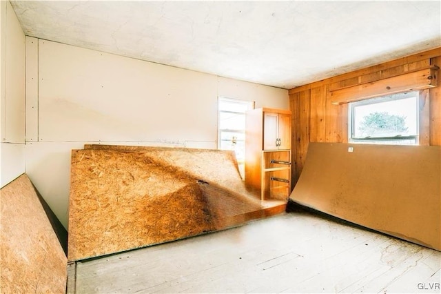 unfurnished bedroom featuring wooden walls