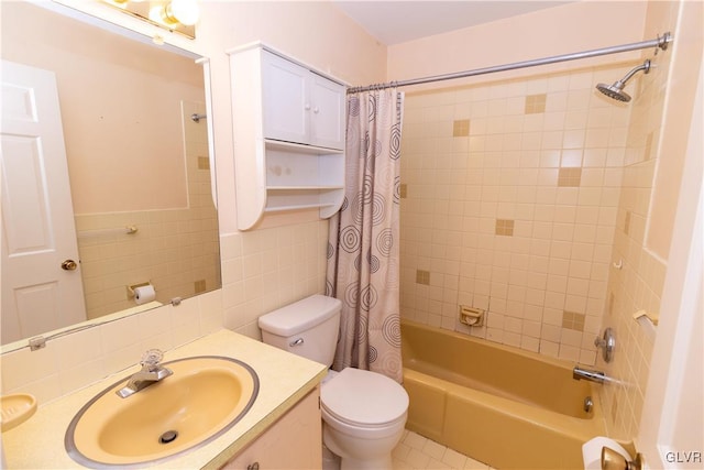 full bathroom featuring shower / bath combo with shower curtain, vanity, tile walls, and toilet