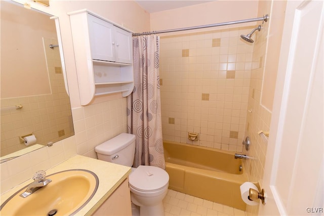 full bathroom featuring vanity, toilet, tile walls, tasteful backsplash, and shower / tub combo