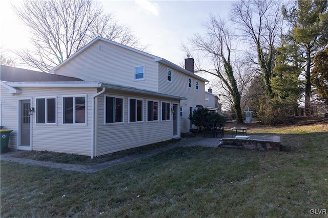 back of house featuring a patio area and a yard