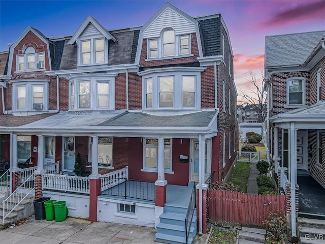 view of front of house featuring cooling unit and a porch