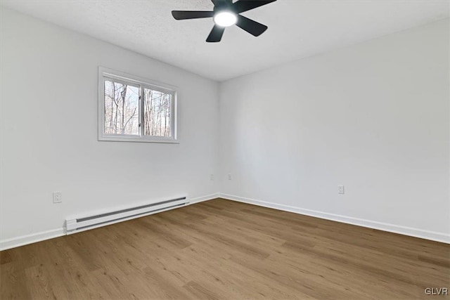 spare room with ceiling fan, light hardwood / wood-style flooring, and a baseboard radiator