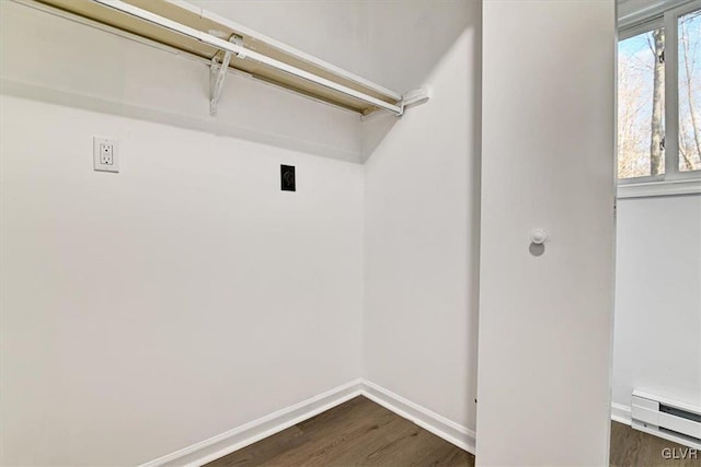 washroom with hookup for an electric dryer, a baseboard radiator, and dark hardwood / wood-style floors