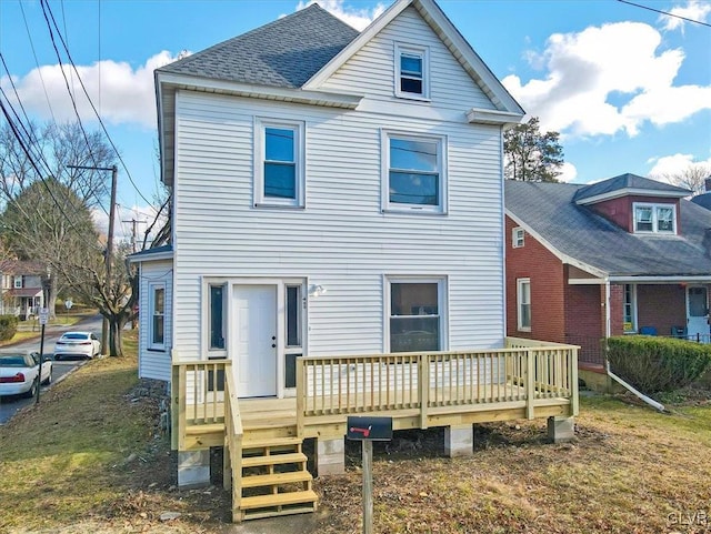 back of house featuring a wooden deck