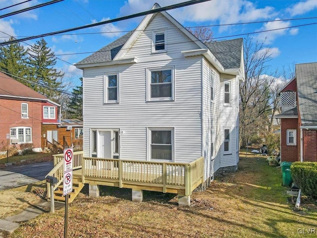 back of house with a lawn and a wooden deck