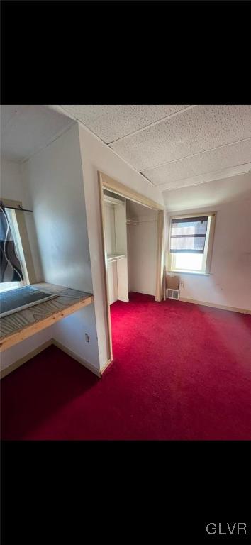 bonus room with carpet and a textured ceiling