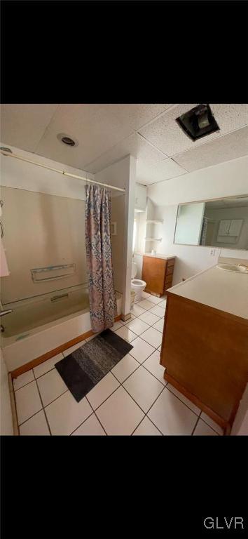 bathroom with tile patterned flooring, vanity, toilet, and a shower with curtain