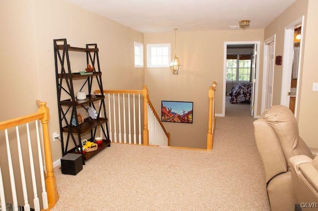 hallway featuring light carpet