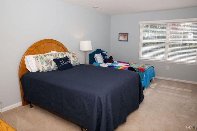 bedroom with light colored carpet