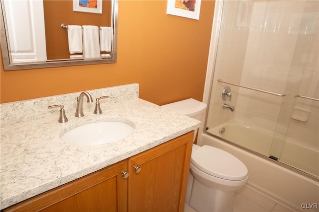 full bathroom with tile patterned floors, toilet, combined bath / shower with glass door, and vanity