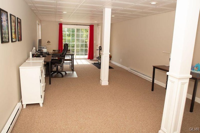 office space with ornate columns, light carpet, and a baseboard radiator