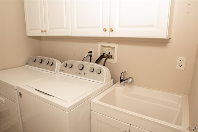 laundry room with washer and dryer, cabinets, and sink