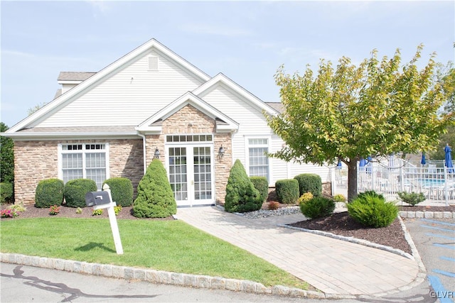 view of front of property with a front lawn and french doors