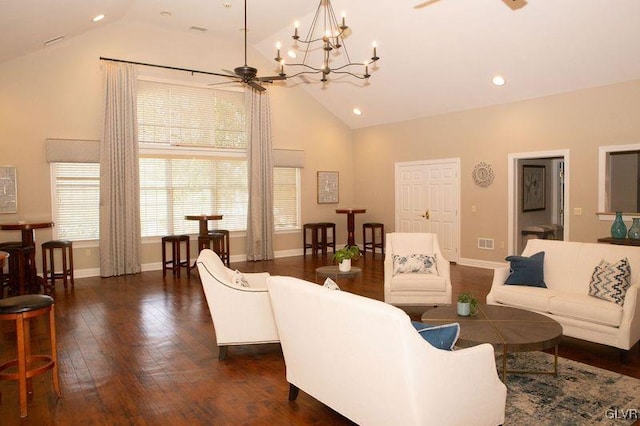 living room featuring ceiling fan with notable chandelier, high vaulted ceiling, and dark wood-type flooring