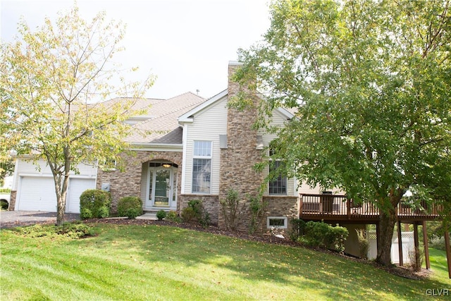 view of front of property featuring a deck, a front lawn, and a garage