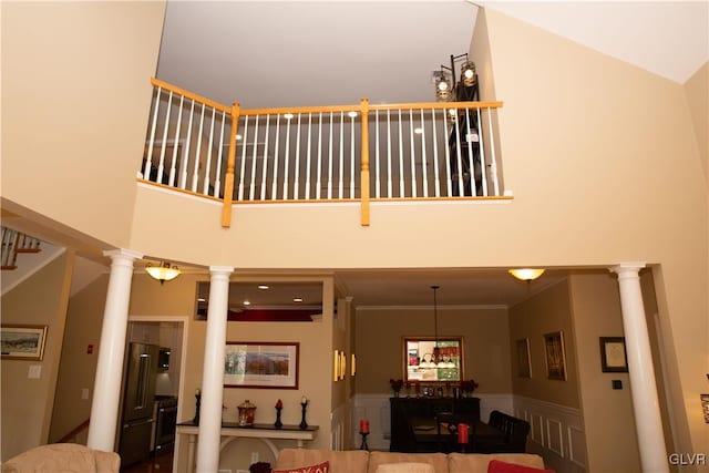 interior space featuring decorative columns and high vaulted ceiling