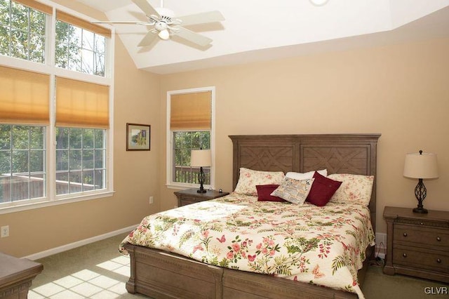 bedroom with ceiling fan, light colored carpet, and vaulted ceiling