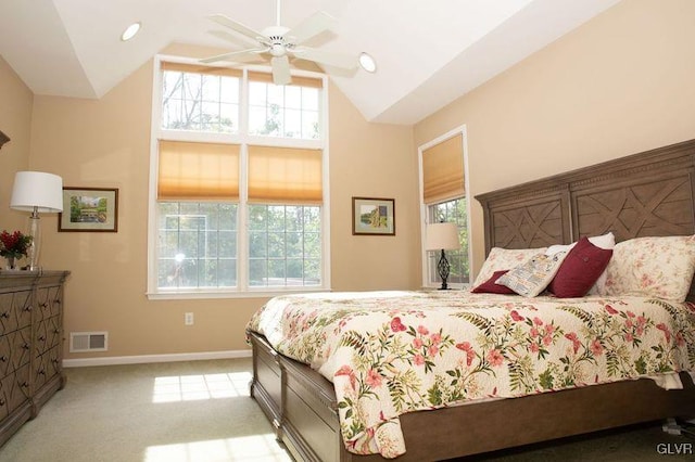 carpeted bedroom featuring multiple windows, ceiling fan, and vaulted ceiling