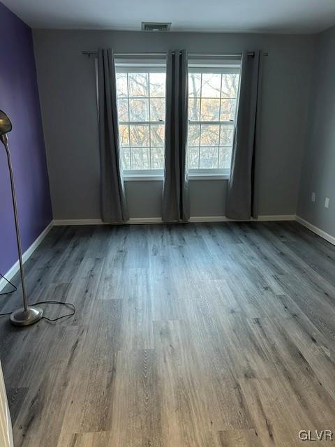 empty room with hardwood / wood-style floors