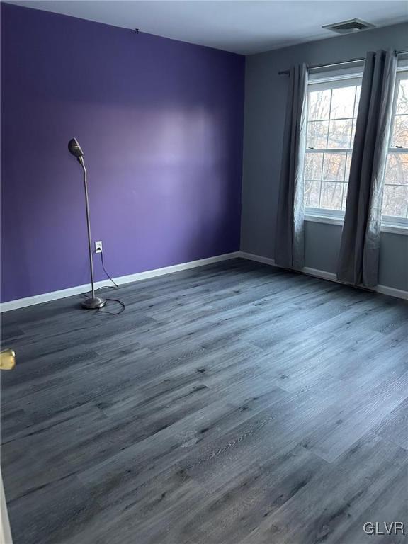 spare room featuring dark hardwood / wood-style flooring