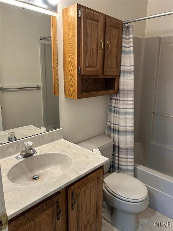 full bathroom with toilet, vanity, tile patterned floors, and shower / bath combo with shower curtain