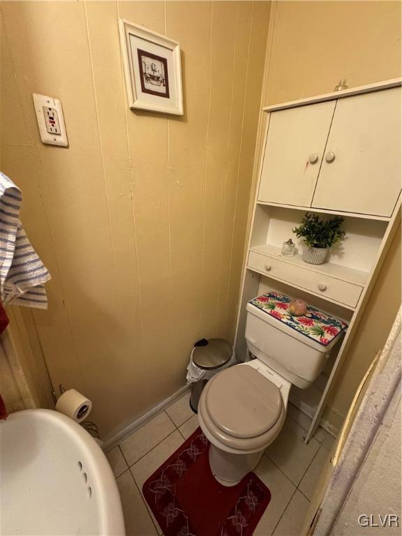 bathroom featuring toilet and tile patterned floors