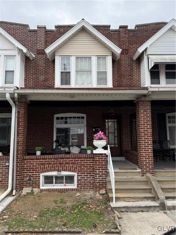 townhome / multi-family property featuring a porch