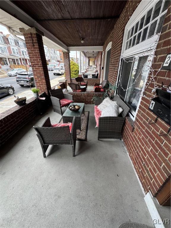 view of patio / terrace featuring an outdoor living space and a porch