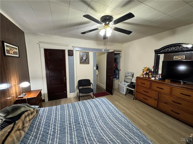 bedroom with ceiling fan and wood-type flooring