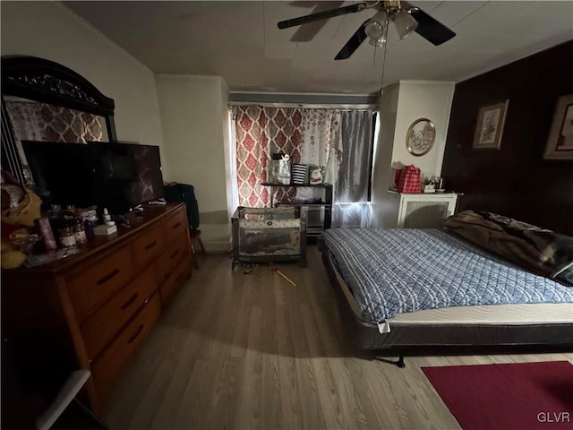 bedroom featuring hardwood / wood-style floors and ceiling fan