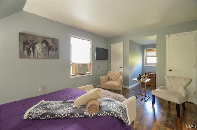 bedroom with cooling unit and dark hardwood / wood-style floors