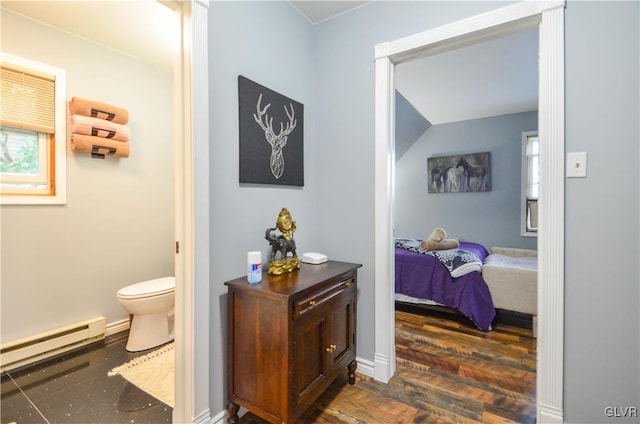 bathroom featuring hardwood / wood-style floors, toilet, and a baseboard heating unit