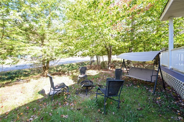 view of yard with a fire pit