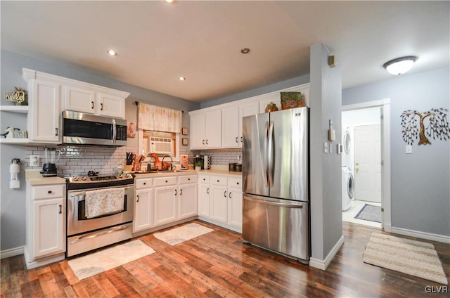 kitchen featuring appliances with stainless steel finishes, dark hardwood / wood-style flooring, and white cabinetry