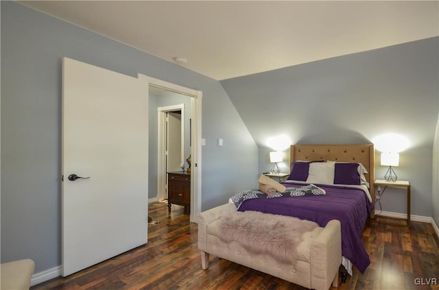 bedroom featuring vaulted ceiling and dark wood-type flooring