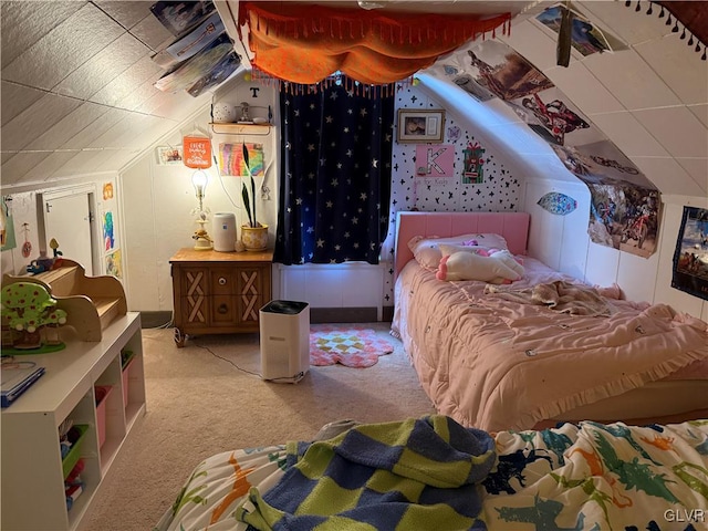 carpeted bedroom with lofted ceiling