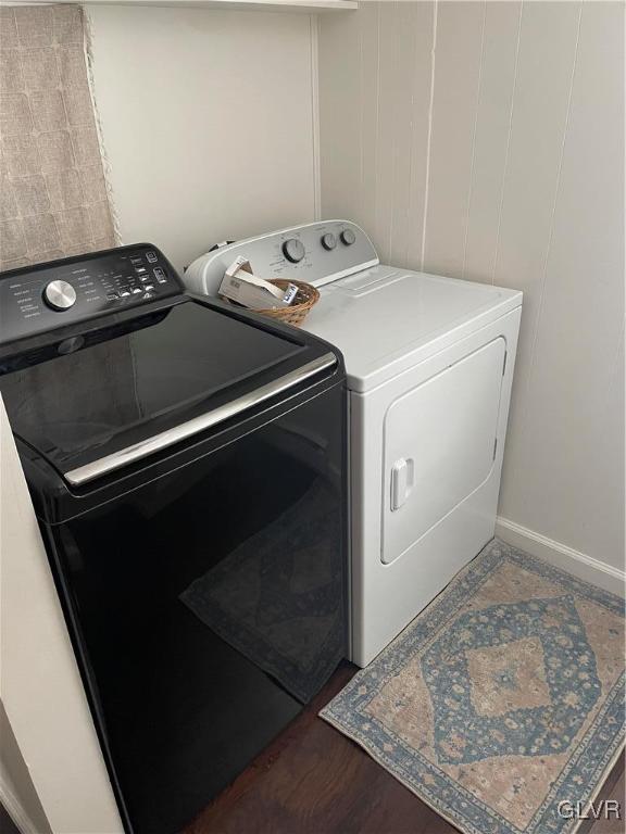 laundry area with separate washer and dryer and dark hardwood / wood-style floors