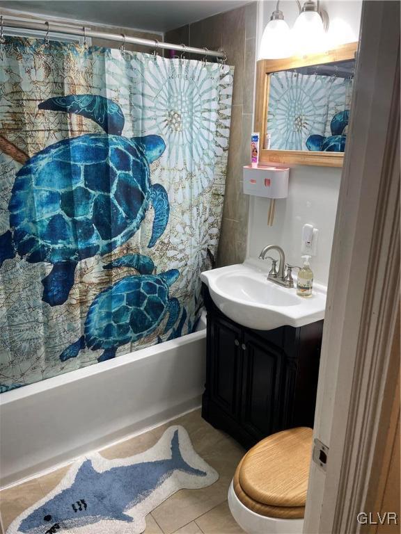 bathroom featuring toilet, vanity, and tile patterned floors